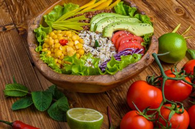 Nohut, avokado, yabani pirinç, Quinoa tohumu, biber, domates, yeşillik, lahana, eski ahşap masada marul ile Buda kase. Sağlıklı vegan gıda.