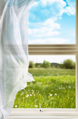 Open window with voile curtains blowing in the breeze looking out onto countryside clipart