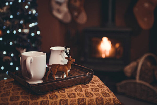 Christmas drinks on try by a roaring log fire
