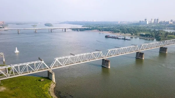 Russia, Novosibirsk - July 19, 2018: First Railway Bridge in Novosibirsk. Panorama of the city of Novosibirsk. View on the river Ob. Russia, From Dron — Stock Image Russia Novosibirsk July 2018 First Railway Bridge Novosibirsk Panorama City Royalty Free Stock Images