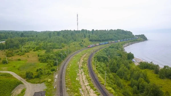 Russia, Baikal. Trans-Siberian Railway, the coast of Lake Baikal. Movement of trains on the iron bridge across the river flowing into Baikal, From Drone
