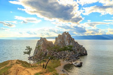 Russia, Lake Baikal. Khuzhir. Tourists walk around Shaman Rock. Olkhon Island, Bay 