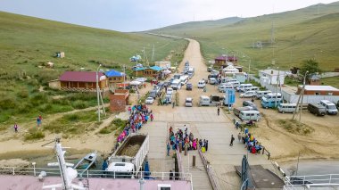 Russia, Olkhon - July 27, 2018: Ferry Semen Batagayev and Olkhon Gate at the pier. Lake Baikal. Ferry to Olkhon Island. From the side of the island., From Drone   clipart