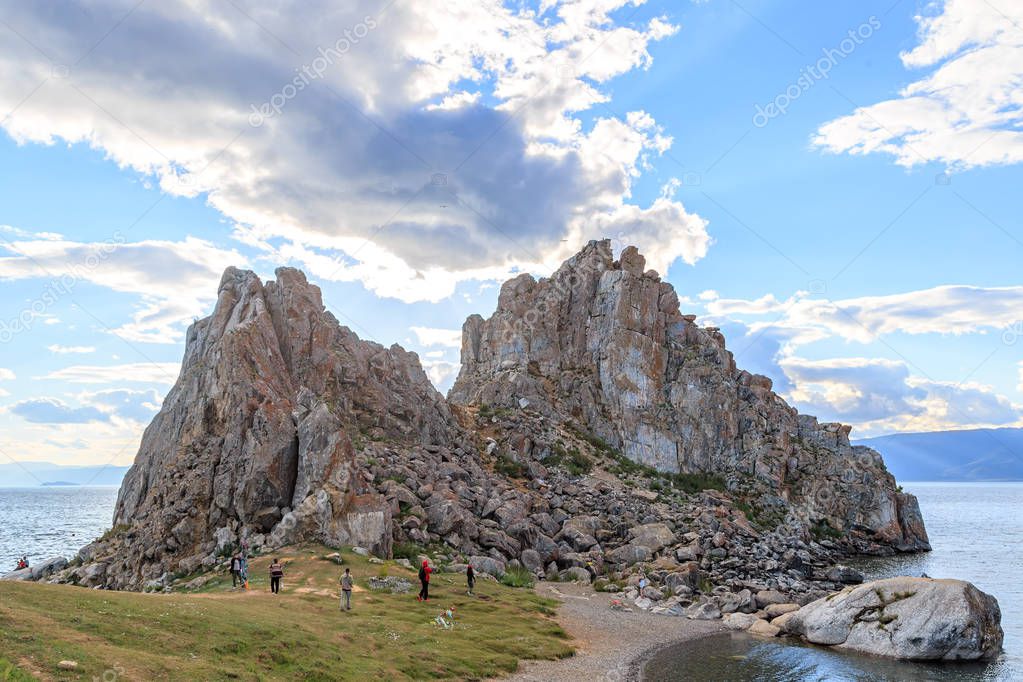 Russia, Lake Baikal. Khuzhir. Tourists walk around Shaman Rock. 