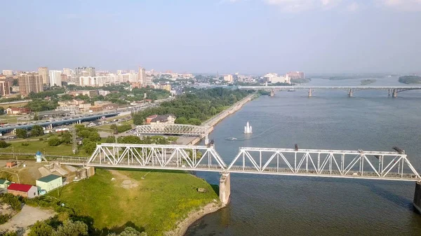 First Railway Bridge in Novosibirsk. Panorama of the city of Novosibirsk. View on the river Ob. Russia, From Dron — Stock Image First Railway Bridge in Novosibirsk. Panorama of the city of Novosibirsk. View on the river Ob. Russia, From Dron Stock Photo