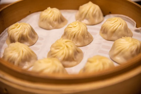 Chinese steamed steamed bun ( baozi ) named Xiaolongbao also called a soup dumpling. It is traditionally prepared in xiolong small bamboo steaming basket. Michelin star awarded Din Tai Fung restaurant