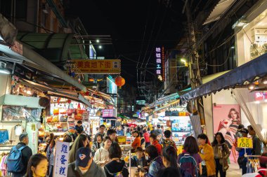 Shilin Night Market food court. A popular and famous destination, endless food stalls, crowds. Largest night market in Taiwan, people get eat, drink and shopping here. Taipei, Taiwan - April 15, 2019. clipart