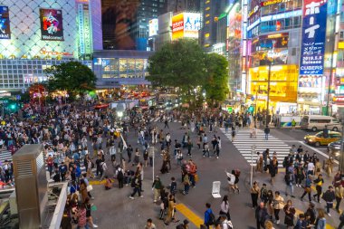 Shibuya Crossing dünyanın en işlek yaya geçitlerinden biridir. Shibuya semtinde yayalar yaya geçidine giriyor. Tokyo, Japonya - 3 Mayıs 2019