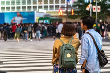 Shibuya Crossing dünyanın en işlek yaya geçitlerinden biridir. Shibuya semtinde yayalar yaya geçidine giriyor. Tokyo, Japonya - 3 Mayıs 2019
