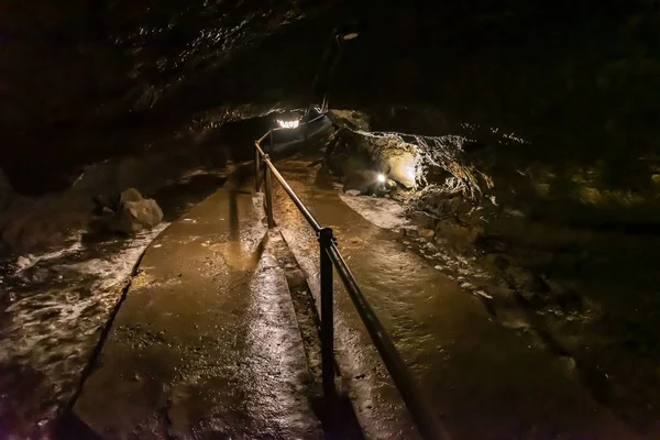 Wind Cave & Ice Cave in Fugaku Japan. The Fuji Fugaku Wind Cave is surrounded by the abundant greenery of the Aokigahara Jukai forest. Once you enter the cave, it is pleasantly cool even in summer