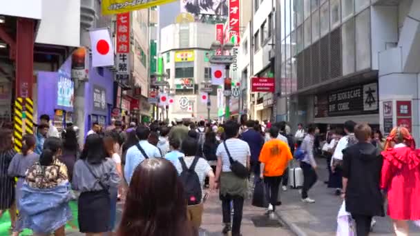 Walking in Shibuya Crossing on daytime ( 4K UHD ). Shibuya Crossing is one of the busiest crosswalks in the world. View of pedestrians crosswalk at Shibuya district normal speed. Tokyo, Japan - May 4, 2019 — Stock Video