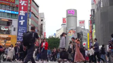 Tokyo, Japonya - 4 Mayıs 2019 : Gündüz Shibuya Geçidi'nde yürüyen yaya ( 4k Uhd Düşük Açı ). Shibuya semtinde normal hızda yayaların yaya geçidi görünümü