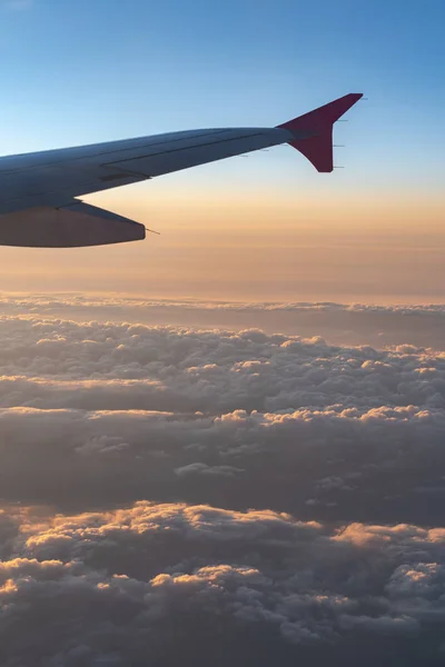 Arriba en el aire, vista de la silueta del ala del avión con el horizonte azul oscuro del cielo y el fondo de la nube en el tiempo de salida del sol, visto desde la ventana del avión —  Fotos de Stock