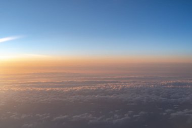 View of dark blue sky horizon in sun rise time, up in the air. viewed from an airplane window clipart