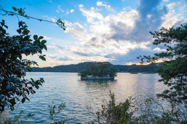 Matsushima Bay in dusk, beautiful islands covered with pine trees and rocks. One of the Three Views of Japan, and is also the site of the Zuigan-ji, Entsu-in and Kanrantei. in Miyagi Prefecture, Japan clipart