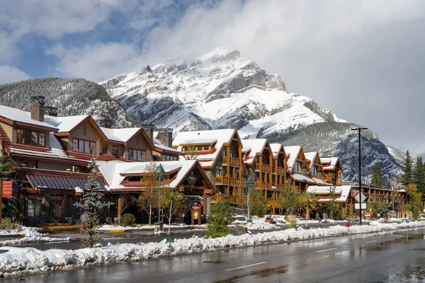 Banff, Alberta, Canada - OCT 14 2020 : Street view of Banff Avenue in autumn and winter snowy season sunny day during covid-19 pandemic period. — Stock Photo, Image