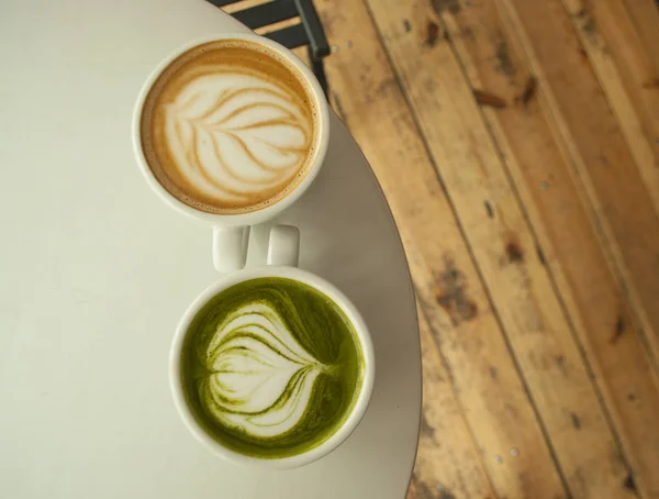 Dua Cangkir Teh Matcha Dan Cappuccino Dengan Seni Latte Yang — Stok Foto