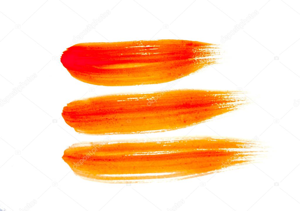 Orange color paint strokes isolated on white background.