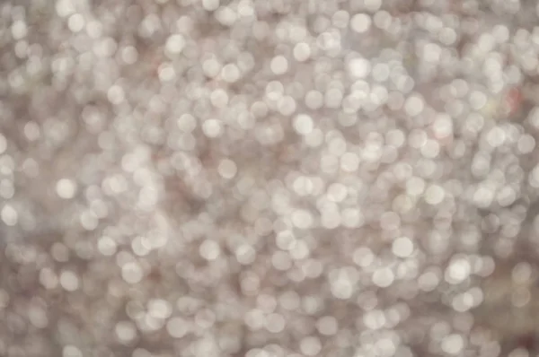Silver glittery shimmering background with blinking details.