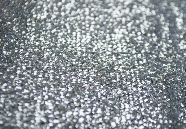 Silver glittery shimmering background with blinking details.