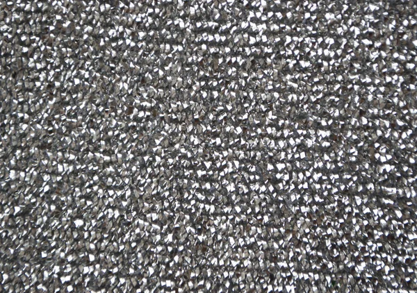 Defocused silver glittery shimmering background with blinking details.