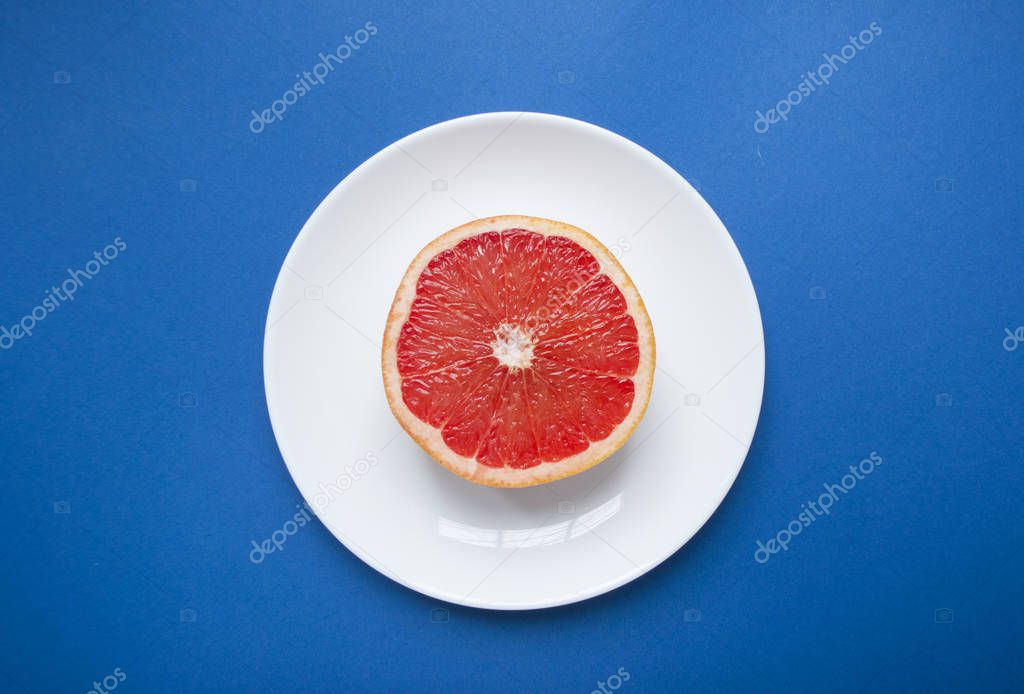 Ripe grapefruit on blue background.