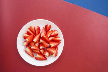 Beyaz tabakta taze çilek üst görünümü.