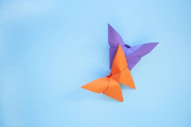 Mavi arka plan üzerinde Origami kağıt kelebekler.