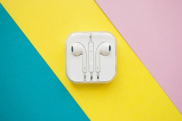Wireless earphones in a white plastic case. — Stock Photo, Image