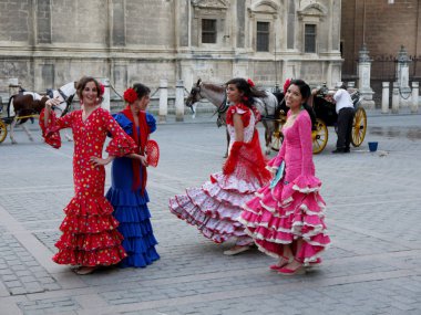 Seville İspanya/16 Nisan 2013 / parlak icoloured geleneği elbiseler olun yıllık giderken genç İspanyol bayanlar dikdörtgen Sevilla şehir İspanya'Nisan bahar adil düzenlenen
