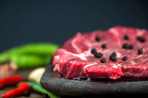 slices of raw beef chuck steak with vegetable