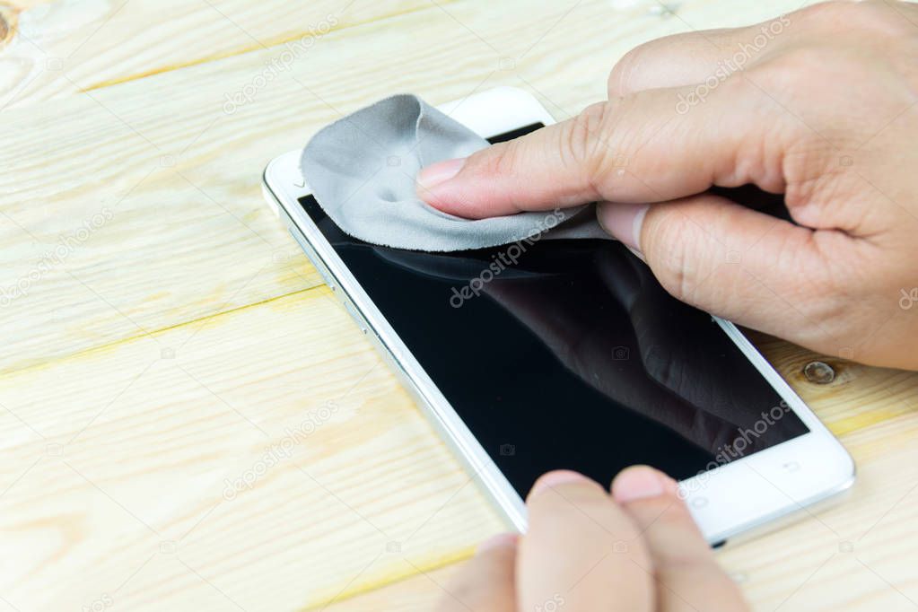 cleaning smart phone screen with microfiber cloth
