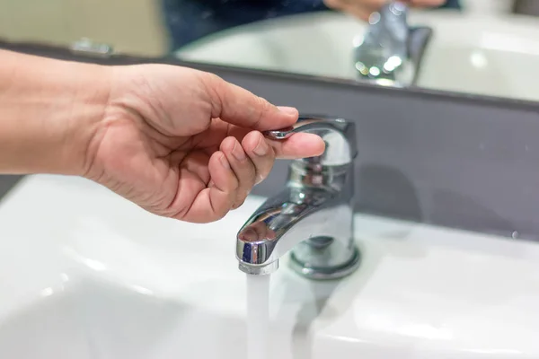Hand opening water tap — Stock Photo, Image