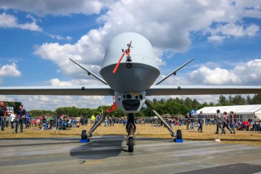 VOLKEL, NETHERLANDS - JUN 15, 2013: Military General Atomics MQ-1 Predator UAV drone on display at the Royal Netherlands Air Force Open Day. clipart