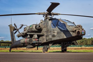 KLEINE BROGEL, BELGIUM - SEP 8, 2018: Royal Netherlands Air Force Boeing AH-64D Apache attack helicopter on the tarmac of Kleine-Brogel Airbase. clipart