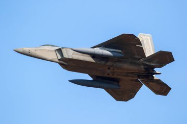 US Air Force Lockheed Martin F-22 Raptor stealth air superiority fighter jet aircraft taking off from Spangdahlem Air Base. clipart