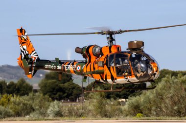 ZARAGOZA, SPAIN - MAY 20,2016: Tiger painted French Army SA341 Gazelle helicopter landing on Zaragoza airbase. clipart