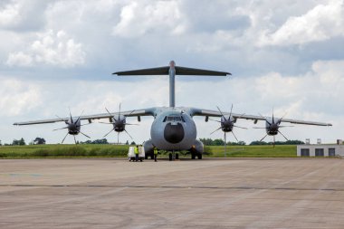 BERLIN, GERMANY - JUN 2, 2016: Airbus A400M military cargo plane on the tarmac of Berlin-Schonefeld Airport. clipart