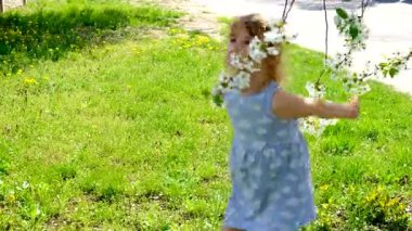 Child in a blooming garden in spring. Selective focus. Kid.