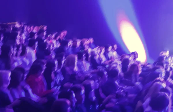 Blurred rows of people sitting at event abstract