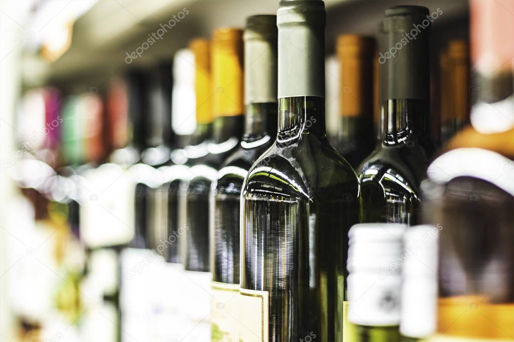 Close up of wine bottles on shelf in store