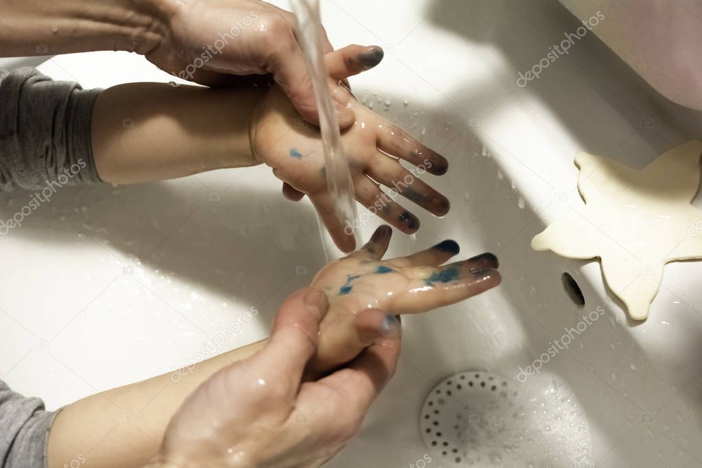 Washing child hands of color