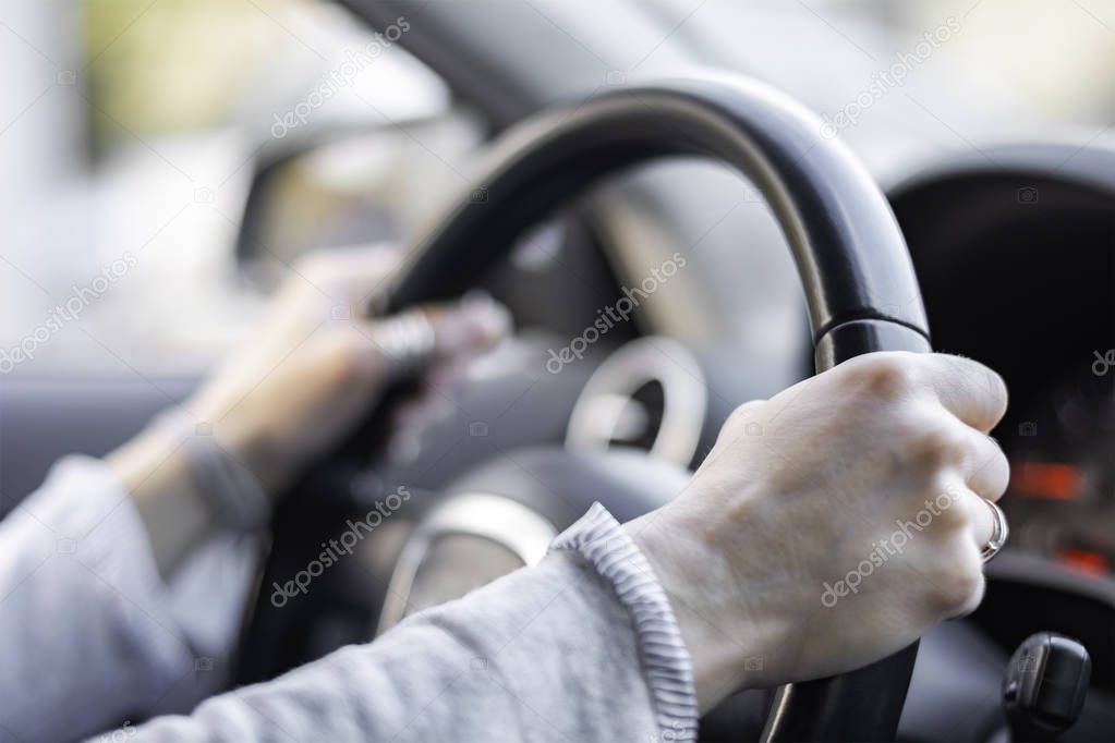Close up of hands on steering wheel shallow dof
