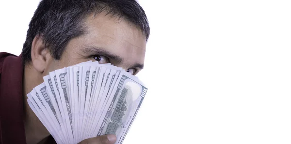 Man holding a widespread of one hundred dollar bills covering his face looking directly at camera greedy lustful satisfied victorious copy space negative excited greed lustfully horizontal copy space — Stock Photo, Image