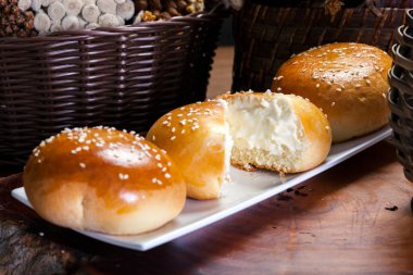 round sweet bread with sesame stuffed with cream cheese clipart