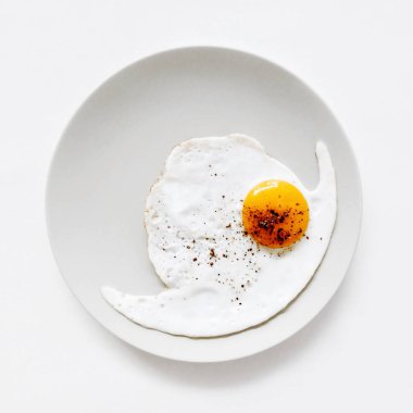 Beyaz bir arka plan üzerine bir tabak kızarmış yumurta kapatmak kadar üstten görünüm