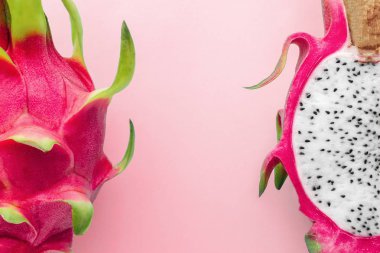 Fresh organic dragon fruit on a pink background, creative summer food concept clipart