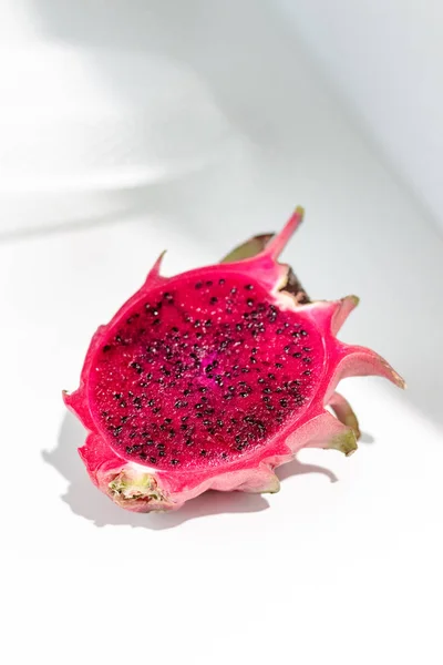 Fresh organic red dragon fruits on a white background, creative healthy food concept