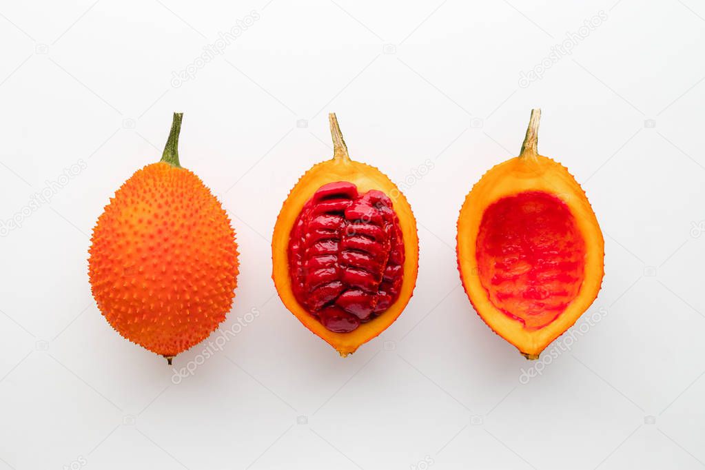 Gac fruit on a white background, creative flat lay food concept