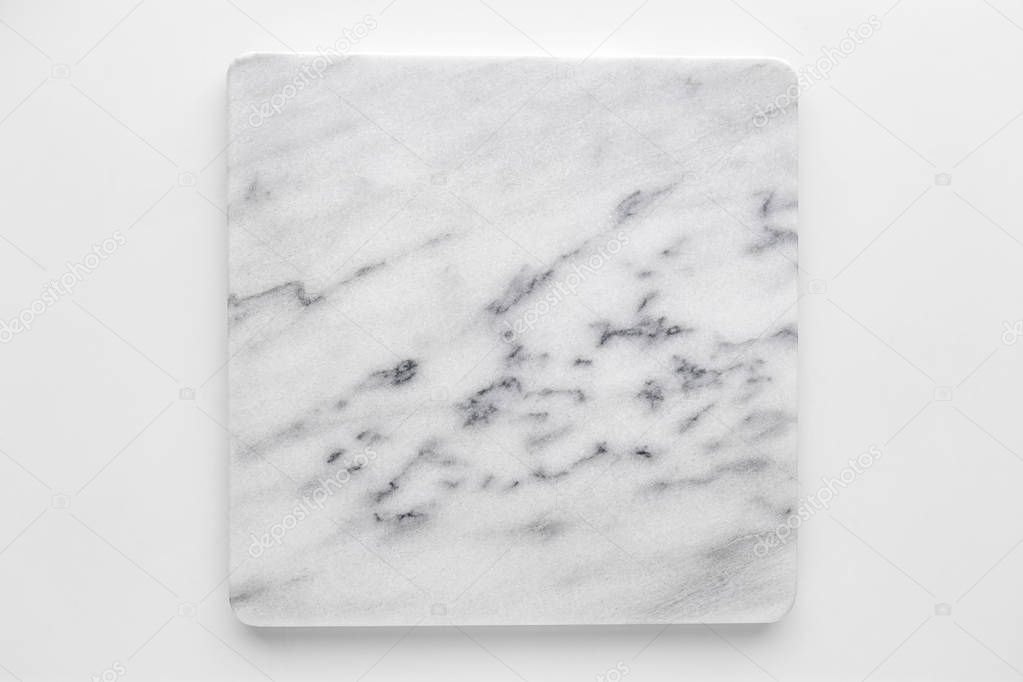 Square white marble cutting board on a white background, light gray marble stone texture background